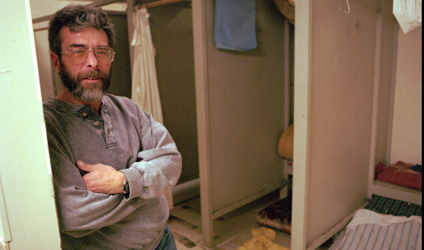 Tim Stone, former manager of the Manchester homeless shelter in Manchester, New Hampshire, leans against a wall in the shower stall area of the shelter. Reducing homelessness is one of the areas that governments in the United States are exploring for Social Impact Bonds. (AP/Jack Ainsworth)