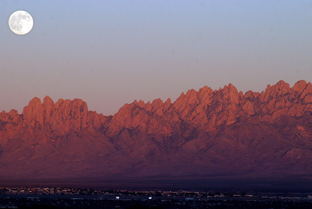 As dusk settles upon Las Cruces, New Mexico, a full moon emerges from behind the Organ Mountains. Protecting the Organ Mountains-Desert Peaks would be a significant  homage to the people and history of New Mexico during the state’s  centennial anniversary this year. (AP/AP Photo/Las Cruces Sun-News, Shari Vialpando)