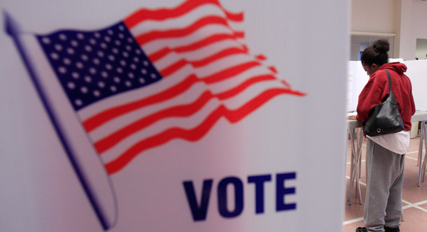 A woman votes at at the Cuyahoga County Board of Elections on January 31, 2012, in Cleveland. Conservative legislators are introducing and passing legislation that  creates new barriers for those registering to vote, shortens the early  voting period, imposes new requirements for already-registered voters,  and rigs the Electoral College in select states. (AP/Tony Dejak)