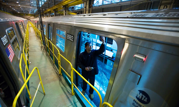 A worker inspects the door mechanism on a New York City subway car at the Kawasaki manufacturing facility in Yonkers, New York, in 2008. The manufacturing industry added 16,000 new jobs in April. (AP/Mark Lennihan)
