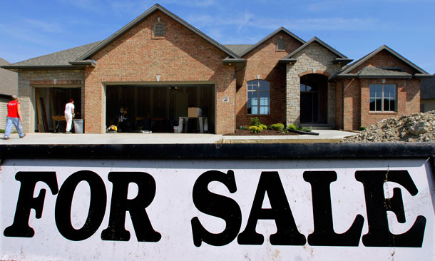 Construction workers finish up on a new home seen for sale in Springfield, Illinois. Americans bought more new homes in April, the latest signal that the U.S. housing market is steadily improving. (AP/Seth Perlman)