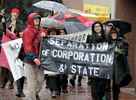 University of Southern Maine students march down Congress Street in Portland, Maine for an organized May Day rally. Robert J. Samuelson's recent suggestion in <i>The Washington Post</i> that federal policy isn’t heavily influenced by the rich and powerful rests on a shaky foundation of misleading numbers and notable omissions. (AP/ Pat Wallenbach)