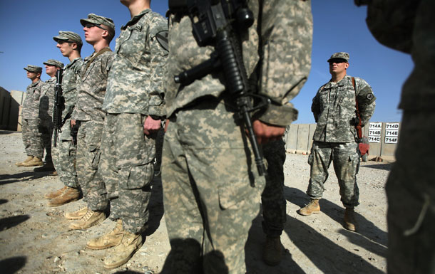 Soldiers from the 3rd Brigade, 1st Cavalry Division, attend a casing of the colors ceremony at Camp Adder, now known as Imam Ali Base, near Nasiriyah, Iraq. Many on-the-ground service members will be denied a pension if military compensation is not reformed.
<br /> (AP/Mario Tama)