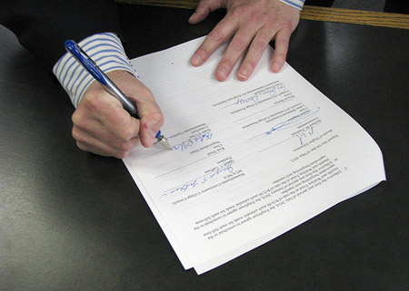 The Social Impact Bond agreement itself—the contract signed by the government agency and the external organization—is critically important to the success or failure of a Social Impact Bond. (Flickr/<a href=http://www.flickr.com/photos/masshighered/7135676497/