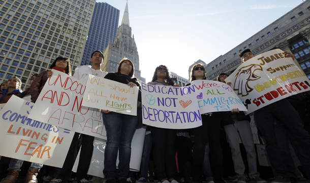 Demonstrators hold signs during a rally for undocumented students, Saturday, March 10, 2012, at Daley Plaza in Chicago. (AP/Nam Y. Huh)