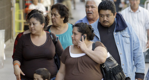 Latinos are seen on Broadway in downtown Los Angeles, where many businesses cater to a Spanish-speaking clientele, on May 11, 2011. The Hispanic share of California’s population grew from just over 25 percent in 1990 to almost 38 percent in 2010. (AP/Reed Saxon)