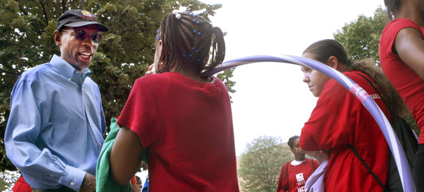 Geoffrey Canada, left, head of Harlem Children's  Zone and the new Promise Academy, talks to a participant of the HCZ Summer Olympics in New York City. HCZ grapples with a problem familiar to those educating pre-schoolers nationwide: the cost and complexity of complying with different sets of requirements. (AP/Mary Altaffer)