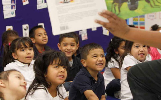 Teacher Pamela Houston reads to her prekindergarten students in Dallas.  Although studies have shown these full-day classes can greatly improve children’s test scores, looming cuts to education funding have put many of these pre-k programs on the chopping block in hundreds of districts across Texas.
<br /> (AP/LM Otero)