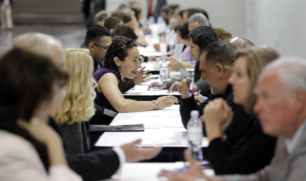 In this June 13, 2012, photo, job seekers have their resumes reviewed at a job fair expo in Anaheim, California. (AP/Jae C. Hong)