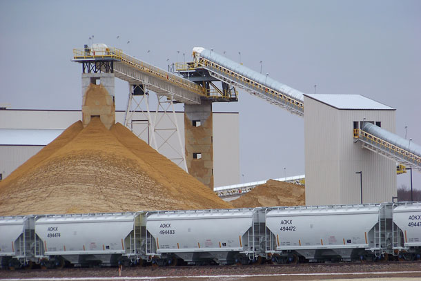 Frac sand destined for the oil and gas fields piles up at the EOG Resources Inc. processing plant in Chippewa Falls, Wisconsin. (AP/ Steve Karnowski)
