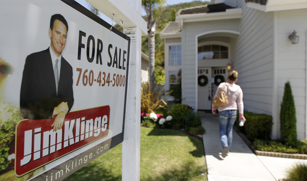 In this June 13, 2012, photo, a woman walks to an open house in San Diego. (AP/Gregory Bull)