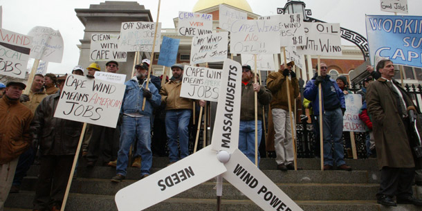 Supporters of the Cape Wind project to put wind turbines on the coast of Cape Cod gather outside the state house in Boston. The project cleared a major hurdle this week with an agreement to share the ocean space with fishermen.
<br /> (AP/Bizuayehu Tesfaye)