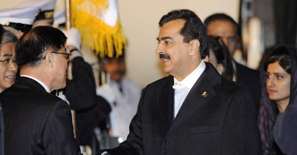 Pakistani Prime Minister Syed Yusuf Raza Gilani, right, is greeted upon his arrival at Gimpo airport in Seoul, South Korea, on March 25, 2012, ahead of the Seoul Nuclear Security Summit. Gilani was disqualified from office this week by the Supreme Court of Pakistan.
<br /> (AP/Liu Jin, Pool)