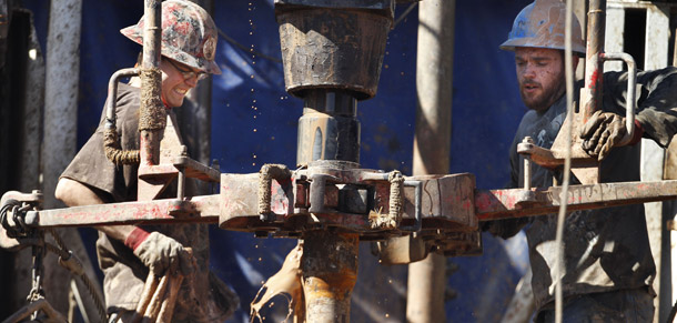 Oil field workers drill into the Gypsum Hills near Medicine Lodge, Kansas, on February 21, 2012. A new House bill would open public lands to gas and oil drilling.
<br /> (AP/Orlin Wagner)