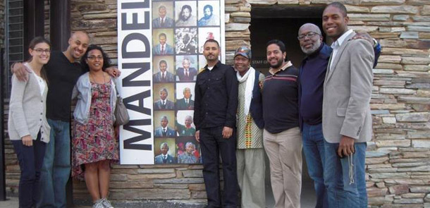 Center for American Progress Leadership Institute fellows pose for a group photo at the entrance to the Apartheid Museum in Soweto, South Africa.  (Right to left: Rebecca Friendly, Tonye Lofton, Alicia Criado, Alejandro Reyes, Jamiah Adams, Samir Paul, Sam Fulwood III, and Donald Gatlin.) (Center for American Progress)