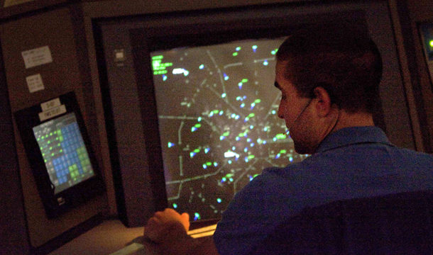 An air traffic controller works in a terminal radar approach control room at the Atlanta TRACON in Peachtree City, Georgia. Sequestration would cut about $1.5 billion from the Federal Aviation Administration budget, including possibly more than $900 million from the salaries of air traffic controllers. That would require a 10 percent to 12 percent cut in hours worked by controllers, forcing a reduction in takeoffs and landings. (AP/David Goldman)