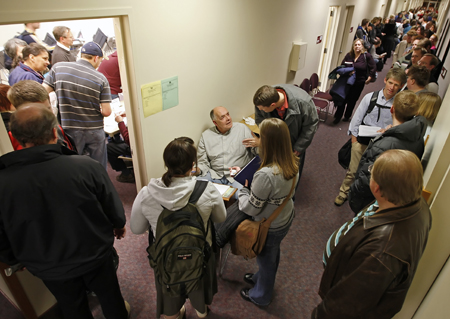 Bob Allen, center, takes voters' names as more than 100 people stand in line to vote at the Harmon building on the campus of Brigham Young University in Provo, Utah, February 5, 2008. (AP/George Frey)