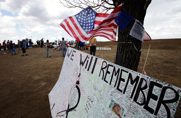 A U.S. flag flies above a message board that reads