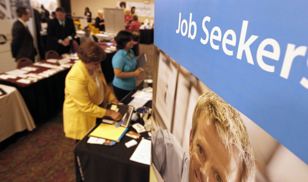 People walk by recruiters at a jobs fair in the Pittsburgh suburb of Green Tree, Pennsylvania, Tuesday, July 10, 2012. (AP/Keith Srakocic)