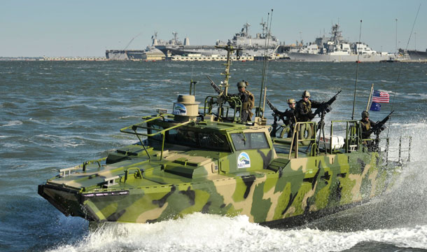 In this photo released by the U.S. Navy, sailors assigned to Riverine Group 1 conduct maneuvers aboard Riverine Command Boat at Naval Station in Norfolk, Virginia. The boat is powered by an alternative fuel blend of 50 percent algae-based and 50 percent NATO F-76 fuels to reduce total energy consumption on naval ships. (AP Photo/U.S. Navy,Specialist 2nd Class Gregory N. Juday)