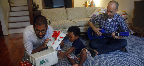 Rumaan Alam, 33, and David Land, 37, play with their son Simon, 2, at home in Brooklyn. Alam and Land adopted Simon after getting married in California in 2008 before the state banned same sex marriages five months later. They plan to get married again in New York for Simon's benefit. (AP/Bebeto Matthews)