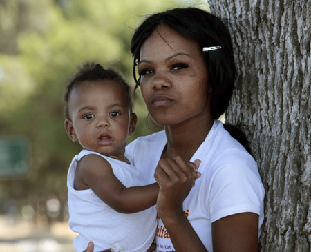 A single mother poses with her daugher in Sacramento, California. Mothers of color face many barriers to taking care of their families including poverty, lack of access to child care, and high incarcertation rates. (AP/Rich Pedroncelli)