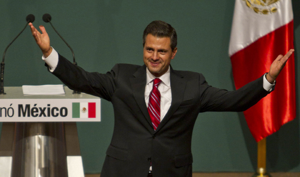 President-Elect Enrique Peña Nieto gestures before supporters at his party's headquarters in Mexico City, early Monday, July 2, 2012. (AP/Christian Palma)