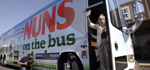 Sister Simone Campbell, executive director of NETWORK, waves as she steps off the bus during a stop on the first day of a nine-state Nuns on the Bus tour, June 18, 2012, in Ames, Iowa. The nuns' tour draws attention to the immorality of Rep. Paul Ryan's budget.  (AP/Charlie Neibergall)