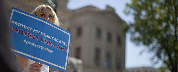 A woman attends a demonstration in support of President Barack Obama's health care overhaul on March 26, 2012 in Atlanta. The recent Supreme Court decision upholding Obamacare ensures that the  law will continue to expand access to important health services. (AP/David Goldman)