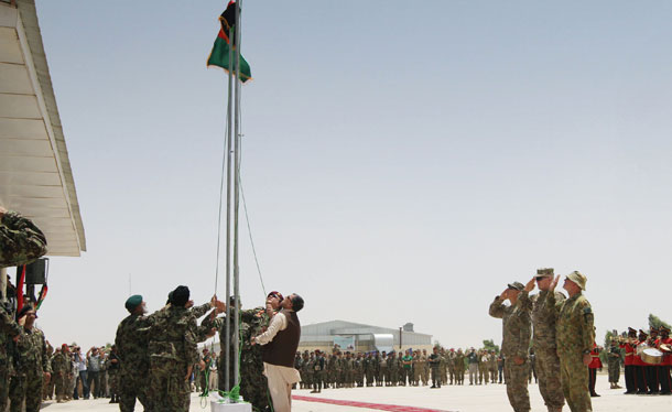 Afghan security forces raise Afghanistan's flag, replacing NATO's flag during the third phase of transfer of authority from NATO troops to Afghan security forces in July. The process of taking over security from the NATO-led forces should be completed by the end of 2014, when Afghanistan will take over the full leadership of its own security duties.  (AP/Allauddin Khan)