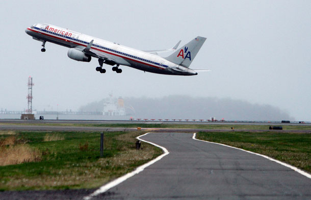 An American Airlines jet takes off from Logan International Airport in Boston under cloudy skies. (AP/ Michael Dwyer)