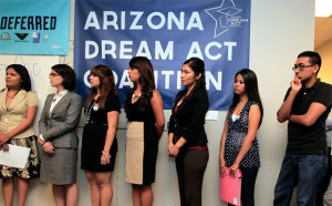 Los jóvenes inmigrantes, junto con los miembros de las organizaciones locales de inmigrantes, se alinean para recibir guías sobre un nuevo programa federal llamado acción diferida que les ayudaría a evitar la deportación, miércoles, 15 de agosto, 2012, en Phoenix. (AP/Ross D. Franklin)