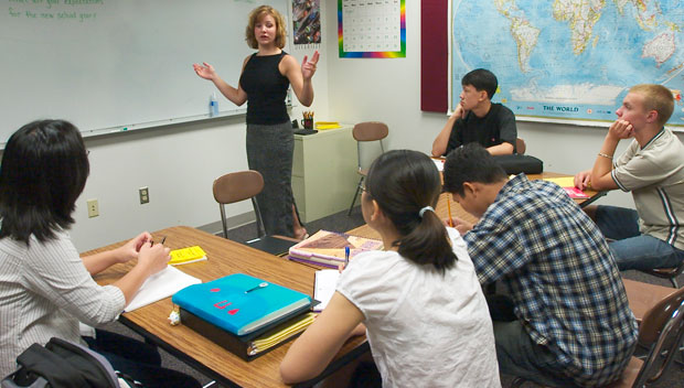 Westside High School English Language Learners teacher Susie Karnik, standing, interacts with her students. Waivers to No Child Left Behind requirements will vastly improve English language learners' education. (AP/Nati Harnik)