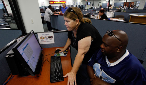 Linda Robinson and her husband Timothy use a computer to look for work at WorkForce One in Hollywood, Florida. Though the economy continued to make modest gains in August, policymakers must do more to ensure economic and job growth in the months to come.<br /> (AP/Lynne Sladky)