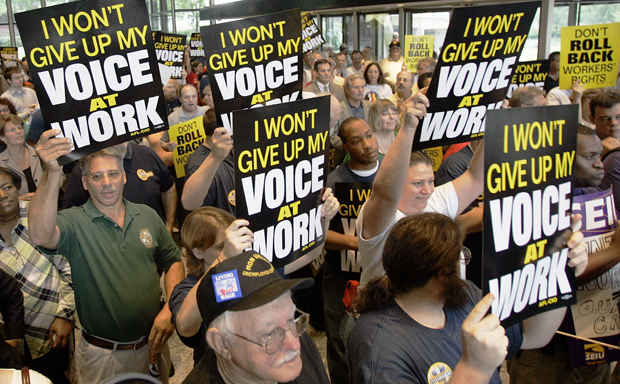 Supporters attending a labor rally hold signs supporting rights to unionize at the United Steelworkers union headquarters in Pittsburgh. (AP/Keith Srakocic)
