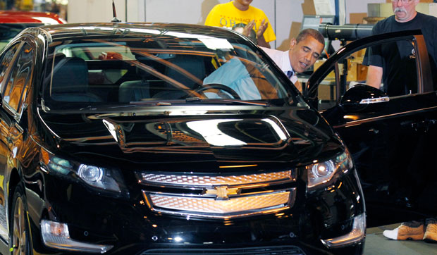 President Barack Obama gets behind the wheel of a new Chevy Volt during his tours of the General Motors Auto Plant in Hamtramck, Michigan. (AP/ Pablo Martinez Monsivais)