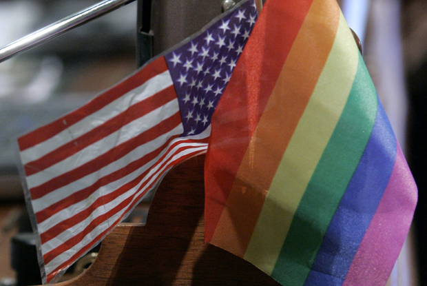 A rainbow flag, identified with the gay and transgender community, decorates the desk of Assemblyman Tom Ammiano (D-San Francisco) at the Capitol in Sacramento, California. (AP/Rich Pedroncelli)