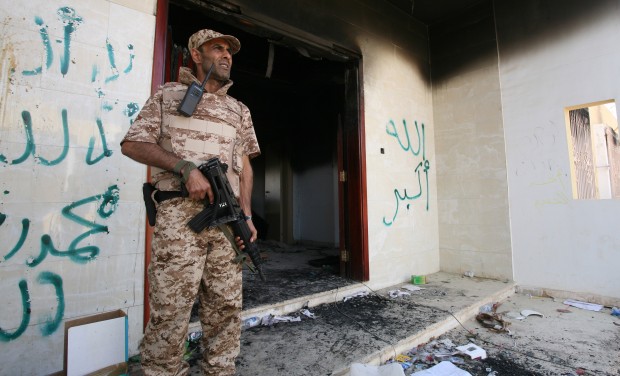 A Libyan military guard stands in front of one of the U.S. Consulate's burnt out buildings in Benghazi, Libya. (AP/ Mohammad Hannon)