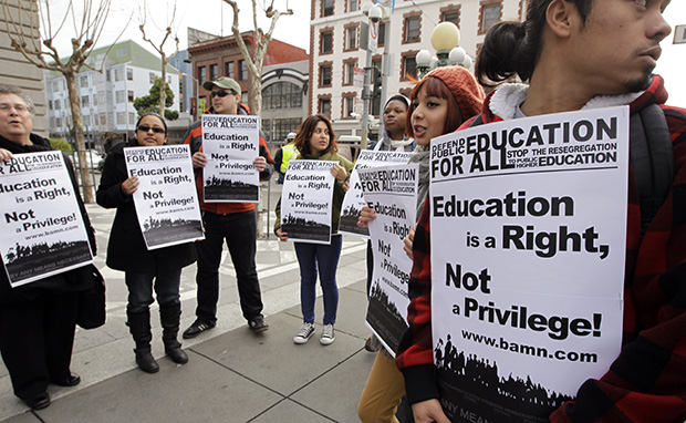 Demonstrators protest outside the U.S. 9th Circuit Court of Appeals, Monday, February 13, 2012, after a panel heard oral arguments in San Francisco in a lawsuit seeking to overturn Proposition 209, which barred racial, ethnic, or gender preferences in public education, employment, and contracting. (AP/Paul Sakuma)