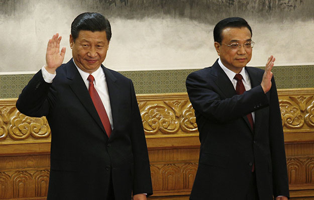 From left, members of the new Politburo Standing Committee Xi Jinping and Li Keqiang wave as they meet journalists in Beijing's Great Hall of the People on Thursday, November 15, 2012. The seven-member Standing Committee, the inner circle of Chinese political power, was paraded in front of assembled media on the first day following the end of the 18th Communist Party Congress. (AP/Vinecnt Yu)