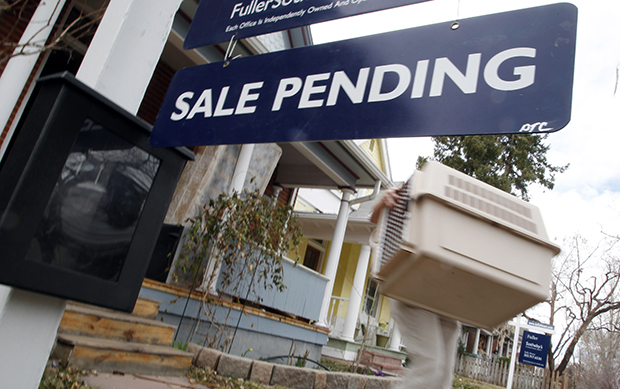 In this Saturday, March 17, 2012, photo, a pending sale sign is seen outside a home on the market in south Denver, Colorado. (AP/David Zalubowski)