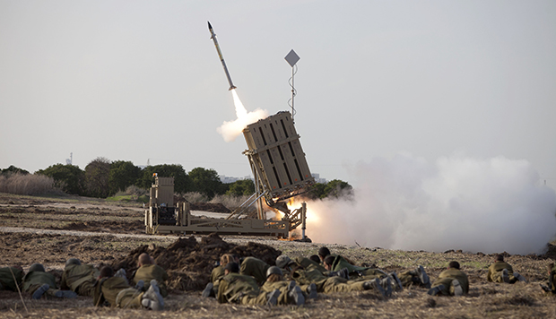 Israeli soldiers lie on the ground as an Iron Dome missile is launched near the city of Ashdod, Israel, Monday, November 19, 2012. (AP/Moti Milrod)