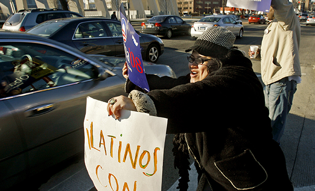 Jackie Reyes holds a sign that says 