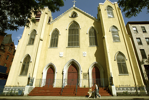 Pedestrians pass by the entrance to St. Brigid's Church in the East Village in New York. The number of Americans who have no particular religious preference—sometimes called the religiously unaffiliated, the unchurched, or just “nones”—is steadily increasing within the United States, with one in five Americans now claiming to eschew organized religion. (AP/Kathy Willens)