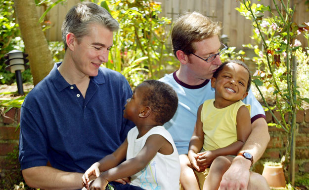 Olivier du Wulf, left, holds his son Laurent, 3, and Steven Boulliane, right, holds his son Patrice, 2, at their home in San Francisco. The Supreme Court must repeal the Defense of Marriage Act in order to ensure that families headed by gay couples have access to the same rights and benefits that opposite-sex spouses and their families do. (AP/Eric Risberg)