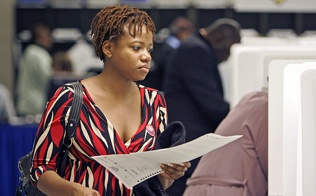 A woman prepares to vote after registering at the Cuyahoga County Board of Elections in Cleveland. (AP/Mark Duncan)