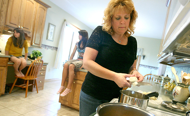 Kim Cramer, 42, makes dinner for her family at her home in Defiance, Ohio. (AP/Madalyn Ruggiero)