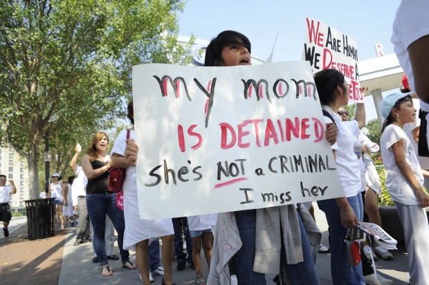 The cumulative effects of harsh immigration laws, increased enforcement actions, and a negative stigmatization of immigrants build upon one another to harm immigrant and citizen alike. (AP/John Amis)
