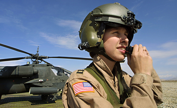 U.S. Army Captain Hellie (last name not given) adjusts her helmet as she walks away from an Apache combat helicopter in Bagram, Afghanistan. (AP/Gurinder Osan)