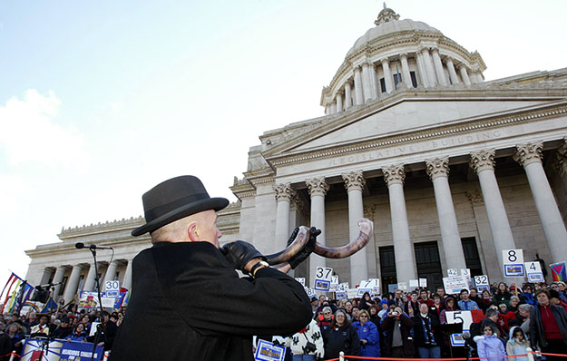 Jon Lellelid, of the Temple De Hirsch Sinai in Seattle, blows a Shofar, or 